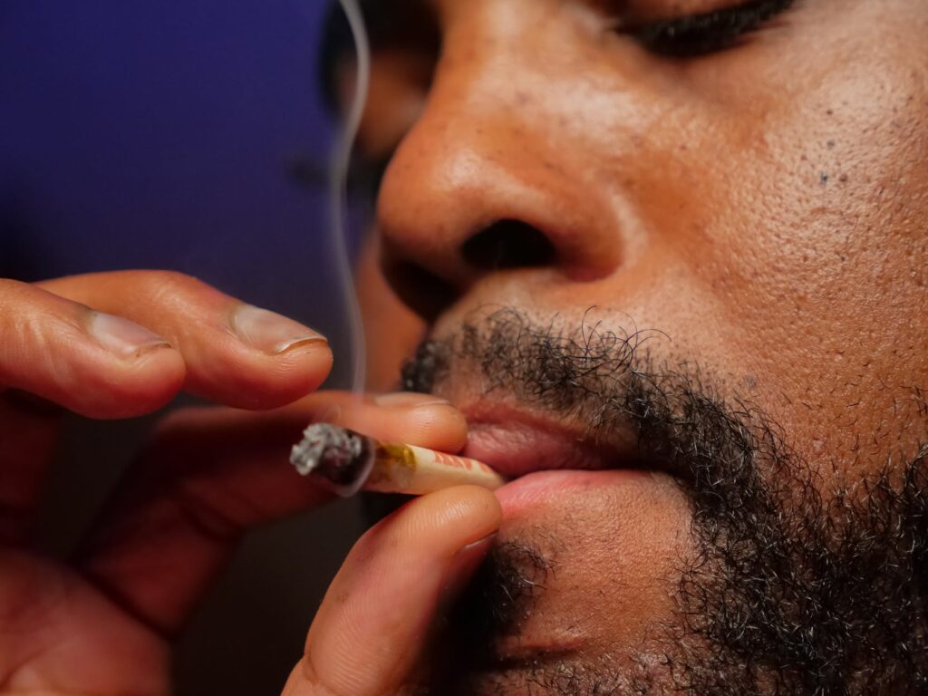 close up photo of man smoking joint